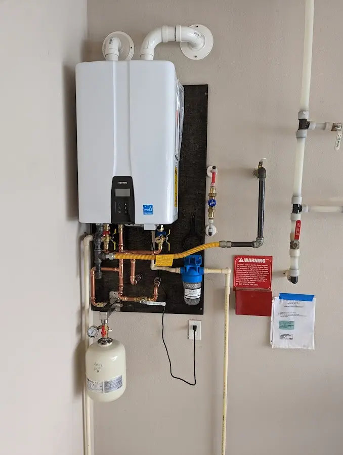 Professional plumber installing copper piping in a Columbus home